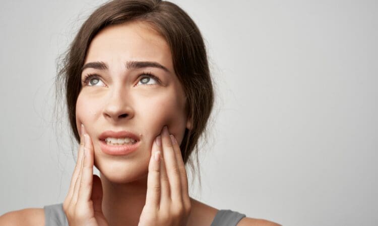 TMJ symptoms range from jaw pain and difficulty chewing to clicking or popping sounds. Some patients also experience headaches.